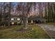 Charming home with a well-manicured lawn, mature trees, and a covered parking area at 5140 Cowart Ct, Powder Springs, GA 30127