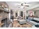 Bright living room with brick fireplace and open layout leading to the kitchen and dining areas at 5140 Cowart Ct, Powder Springs, GA 30127