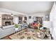 Cozy living room features a brick fireplace, hardwood floors, and access to dining and kitchen areas at 5140 Cowart Ct, Powder Springs, GA 30127