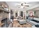 Open-concept living room flows into the kitchen, highlighted by a brick fireplace and comfortable seating at 5140 Cowart Ct, Powder Springs, GA 30127
