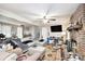 Spacious living room features a cozy brick fireplace, ceiling fan, and access to the backyard at 5140 Cowart Ct, Powder Springs, GA 30127