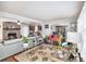 Inviting living room features a brick fireplace, ceiling fan, and seamlessly connects to the dining and kitchen areas at 5140 Cowart Ct, Powder Springs, GA 30127