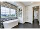 Bright bathroom featuring a soaking tub with modern fixtures and designer tile work at 1276 B Rutledge Rd, Acworth, GA 30101
