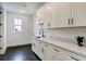 Modern laundry room with ample cabinet space, sleek countertops and dark, stylish hardware at 1276 B Rutledge Rd, Acworth, GA 30101