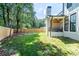 White brick home with a covered porch overlooking a large backyard and tall fence at 1653 Pamela Ne Dr, Brookhaven, GA 30319