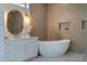 Luxurious bathroom featuring a soaking tub, designer tile, and sleek fixtures at 1653 Pamela Ne Dr, Brookhaven, GA 30319