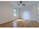 Bright bedroom featuring hardwood floors, a ceiling fan, and a large window at 1653 Pamela Ne Dr, Brookhaven, GA 30319