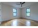 Bright bedroom with hardwood floors, modern ceiling fan and two large windows at 1653 Pamela Ne Dr, Brookhaven, GA 30319