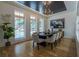 Elegant dining room featuring dark table with seating for eight, modern chandelier, and light hardwood floors at 1653 Pamela Ne Dr, Brookhaven, GA 30319