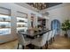 Elegant dining room with dark wood table, shelving and modern chandelier at 1653 Pamela Ne Dr, Brookhaven, GA 30319