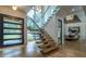 Bright entryway featuring modern stairs with glass railings and floor to ceiling windows at 1653 Pamela Ne Dr, Brookhaven, GA 30319