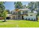 Stunning two-story home with a modern design, lush lawn, and eye-catching natural wood elements at 1653 Pamela Ne Dr, Brookhaven, GA 30319