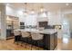 Gourmet kitchen boasts stainless steel appliances, a large island with seating, and custom cabinetry at 1653 Pamela Ne Dr, Brookhaven, GA 30319