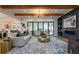 Inviting living room with coffered ceiling, hardwood floors, and seamless access to the outdoor living space at 1653 Pamela Ne Dr, Brookhaven, GA 30319