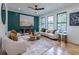 Inviting living room with an accent wall, unique decor, large windows, and hardwood floors at 1653 Pamela Ne Dr, Brookhaven, GA 30319