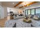 Open-concept living room features hardwood floors, modern furnishings, and seamless flow into a gourmet kitchen at 1653 Pamela Ne Dr, Brookhaven, GA 30319