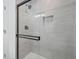 Bathroom tiled shower with black hardware and glass doors at 3048 San Jose Dr, Decatur, GA 30032