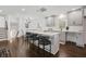 Modern kitchen with gray cabinets, white countertops, and a breakfast bar with black stools at 3048 San Jose Dr, Decatur, GA 30032