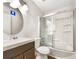Bathroom featuring a shower-tub combo with sliding glass doors, a white toilet, and a modern vanity at 3686 Sweetbriar Cir, Lithia Springs, GA 30122