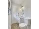 Bright bathroom featuring a vanity sink, toilet, and a window at 3686 Sweetbriar Cir, Lithia Springs, GA 30122