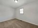 Neutral bedroom featuring carpet flooring, a window for natural light, and a minimalist design at 3686 Sweetbriar Cir, Lithia Springs, GA 30122