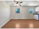 Bright living room with hardwood floors, ceiling fan, and natural light from the two windows at 3686 Sweetbriar Cir, Lithia Springs, GA 30122