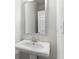 Clean bathroom features a pedestal sink with silver fixtures and a large mirror at 3856 Lockaby Way, Lawrenceville, GA 30044