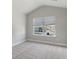 Bright bedroom with carpeted floors, a large window providing natural light, and neutral walls at 3856 Lockaby Way, Lawrenceville, GA 30044
