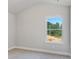 Cozy bedroom with carpeted floors, window providing natural light, and neutral walls for a tranquil atmosphere at 3856 Lockaby Way, Lawrenceville, GA 30044