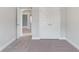 Bedroom featuring carpeted floors and a double-door closet for ample storage space at 3856 Lockaby Way, Lawrenceville, GA 30044