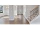 Inviting entryway with hardwood floors, staircase, natural light and views into the dining room at 3856 Lockaby Way, Lawrenceville, GA 30044