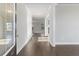 Hallway with dark hardwood floors leading to a glass paned entry door at 3856 Lockaby Way, Lawrenceville, GA 30044
