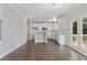 Modern kitchen with white cabinets, stainless steel appliances, hardwood floors, and breakfast area at 3856 Lockaby Way, Lawrenceville, GA 30044