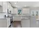 Bright kitchen showcases white cabinets, stainless steel appliances, and granite countertops at 3856 Lockaby Way, Lawrenceville, GA 30044