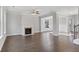 Cozy living room with a fireplace, hardwood floors and a ceiling fan at 3856 Lockaby Way, Lawrenceville, GA 30044