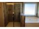 Bathroom with a shower and a tub with frosted glass at 6645 Oak Hill Pass, Fairburn, GA 30213