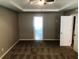 Spacious bedroom featuring tray ceilings, ceiling fan, and neutral color scheme at 6645 Oak Hill Pass, Fairburn, GA 30213