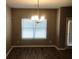 Dining area featuring hardwood floors, a chandelier, and natural light from the window at 6645 Oak Hill Pass, Fairburn, GA 30213