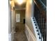 A hallway with wood-trimmed stairs and visible doorway and a rear entrance beyond at 6645 Oak Hill Pass, Fairburn, GA 30213