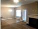 Open living space with a dining area, fireplace, and access to the outdoors at 6645 Oak Hill Pass, Fairburn, GA 30213