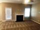 Living room features fireplace, ceiling fan, neutral color palette, and bright natural light at 6645 Oak Hill Pass, Fairburn, GA 30213