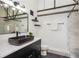 Stylish bathroom with a sleek black vessel sink, modern fixtures, and hexagon tile flooring at 1661 La France Ne St # 314, Atlanta, GA 30307