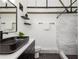 Chic bathroom features a marbled tiled shower, hexagon tile floor, and industrial plumbing accents at 1661 La France Ne St # 314, Atlanta, GA 30307