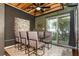 Dining room with a glass table, six chairs, and a view of the outdoor area through sliding glass doors at 1661 La France Ne St # 314, Atlanta, GA 30307