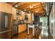 Modern kitchen with stainless steel appliances, light wood cabinets, and a center island with seating at 1661 La France Ne St # 314, Atlanta, GA 30307