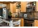 Modern kitchen with stainless steel appliances, light wood cabinets, and a dark countertop island at 1661 La France Ne St # 314, Atlanta, GA 30307