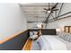 Cozy bedroom featuring hardwood floors, metal beams, a comfy chair, and a stylish queen bed at 1661 La France Ne St # 314, Atlanta, GA 30307