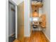 Hallway nook transformed into a functional home office with wooden desk, floating shelves, and natural light at 1661 La France Ne St # 314, Atlanta, GA 30307