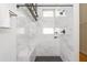 Newly renovated shower with a built in bench, bathtub, and modern black hardware at 1661 La France Ne St # 314, Atlanta, GA 30307
