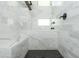 Refined shower with a built-in bench, bathtub, and marble tiling throughout at 1661 La France Ne St # 314, Atlanta, GA 30307